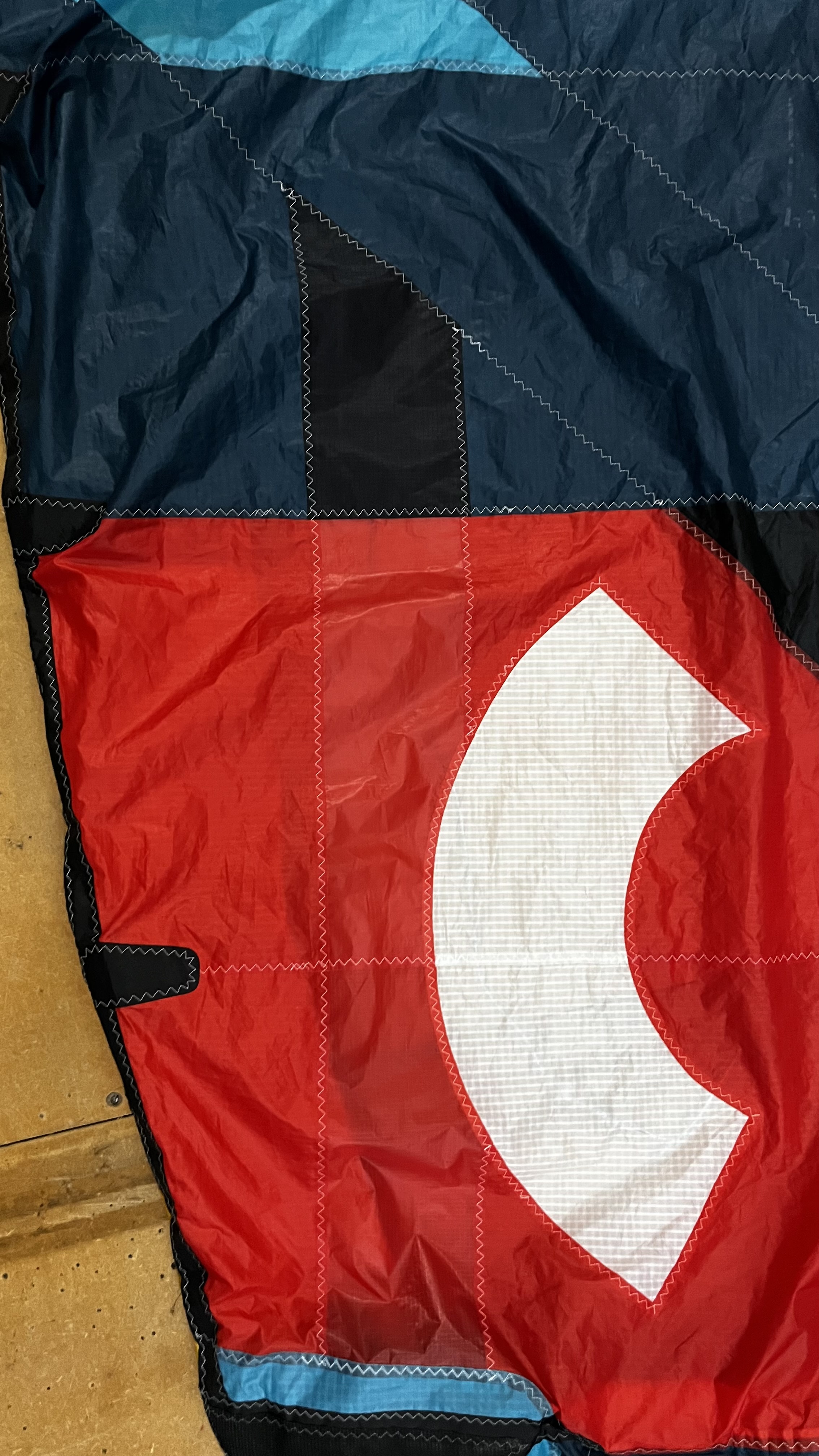 Hand finishing a kite repair